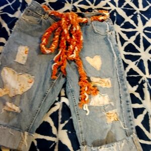 Boho patchwork lace jeans with braided belt.